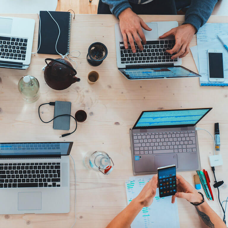 Computadoras y personal de Etix trabajando en tu proyecto